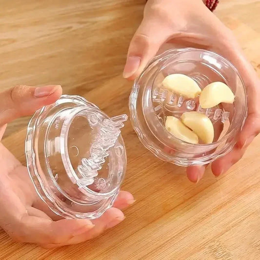 Kitchen multifunctional garlic crusher manual press with clear plastic design and garlic cloves inside